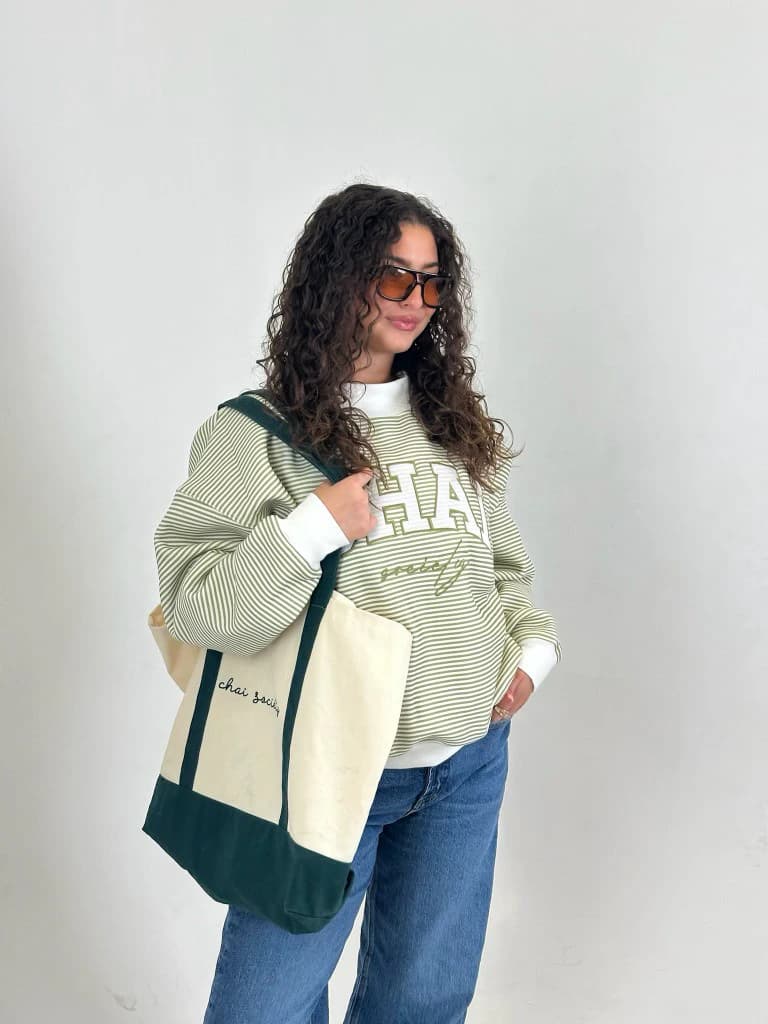 The crewneck worn with the matching cream and forest tote